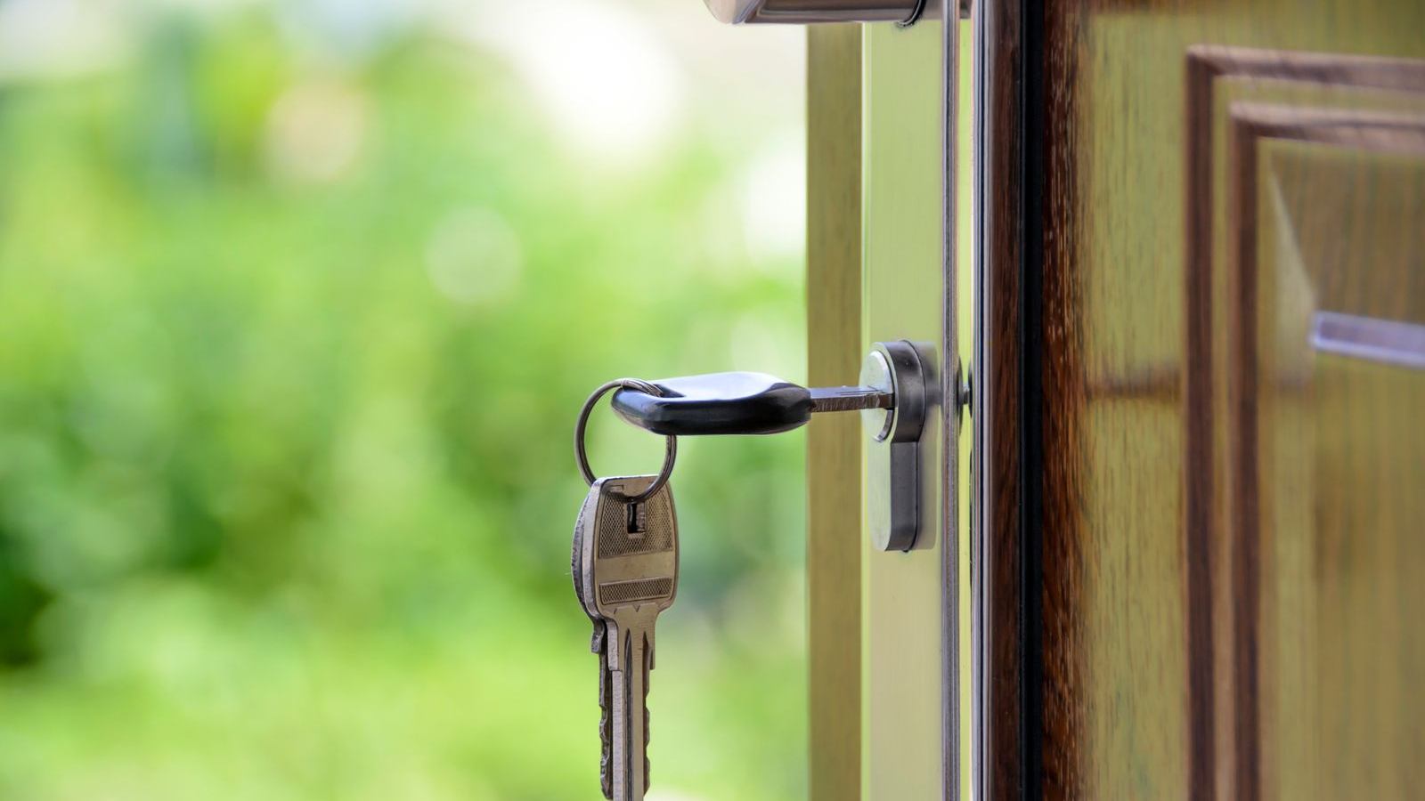 House keys sitting in a front door lock